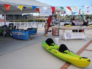 Kayaks and other products displayed on a stand